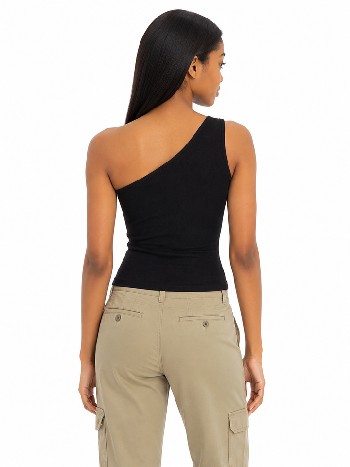 Woman wearing a black one-shoulder top and beige cargo pants on a white background