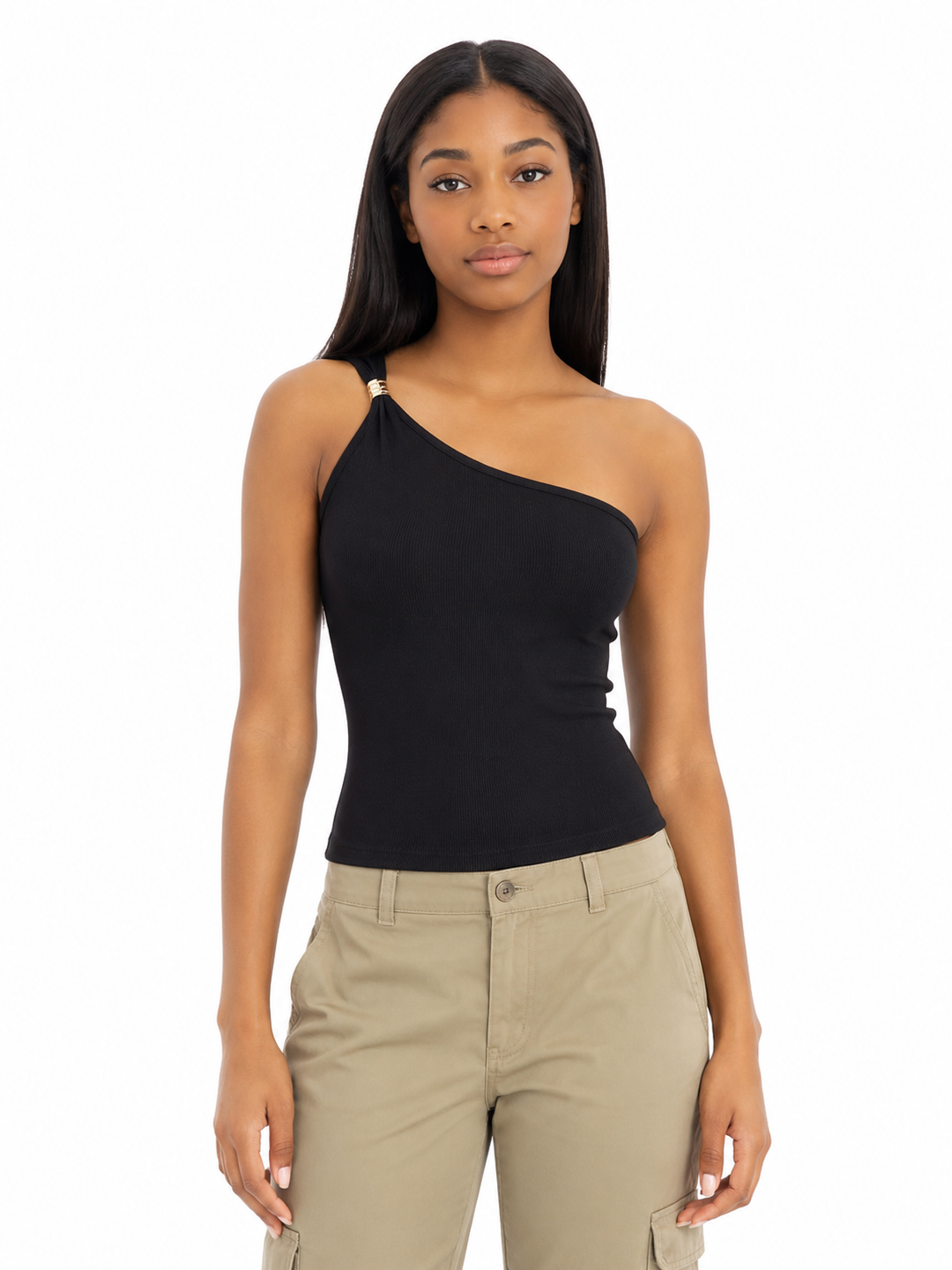 Woman wearing a black one-shoulder top and beige pants on a white background