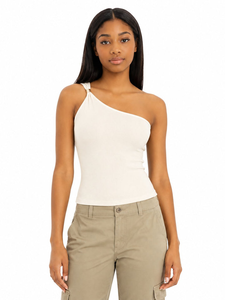 Woman wearing a one-shoulder beige top and beige cargo pants on a white background
