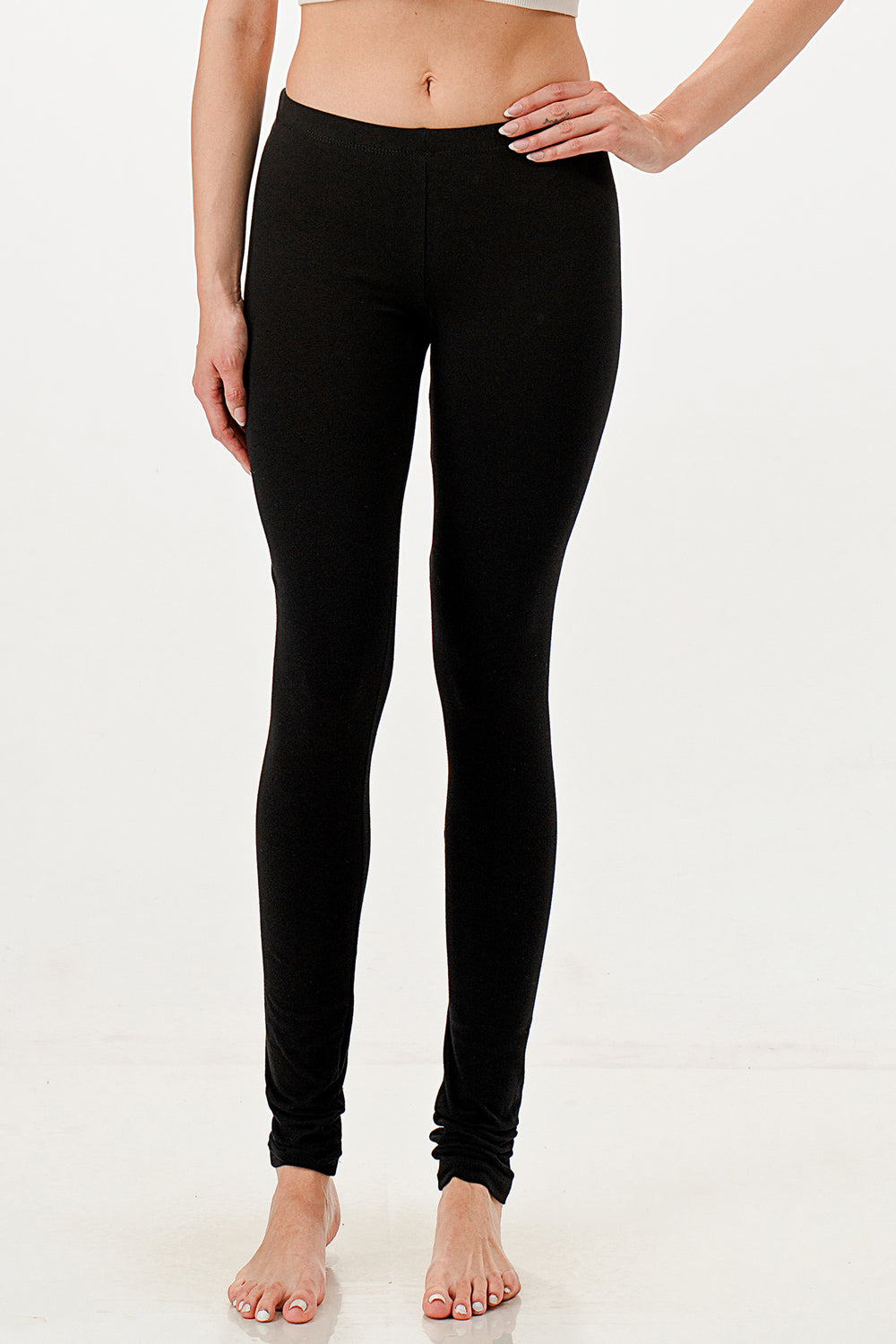 Person wearing black leggings on a white background