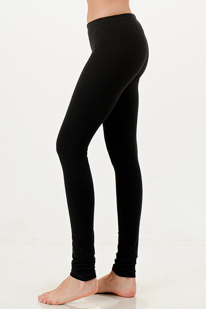 Black leggings worn by a person on a white background