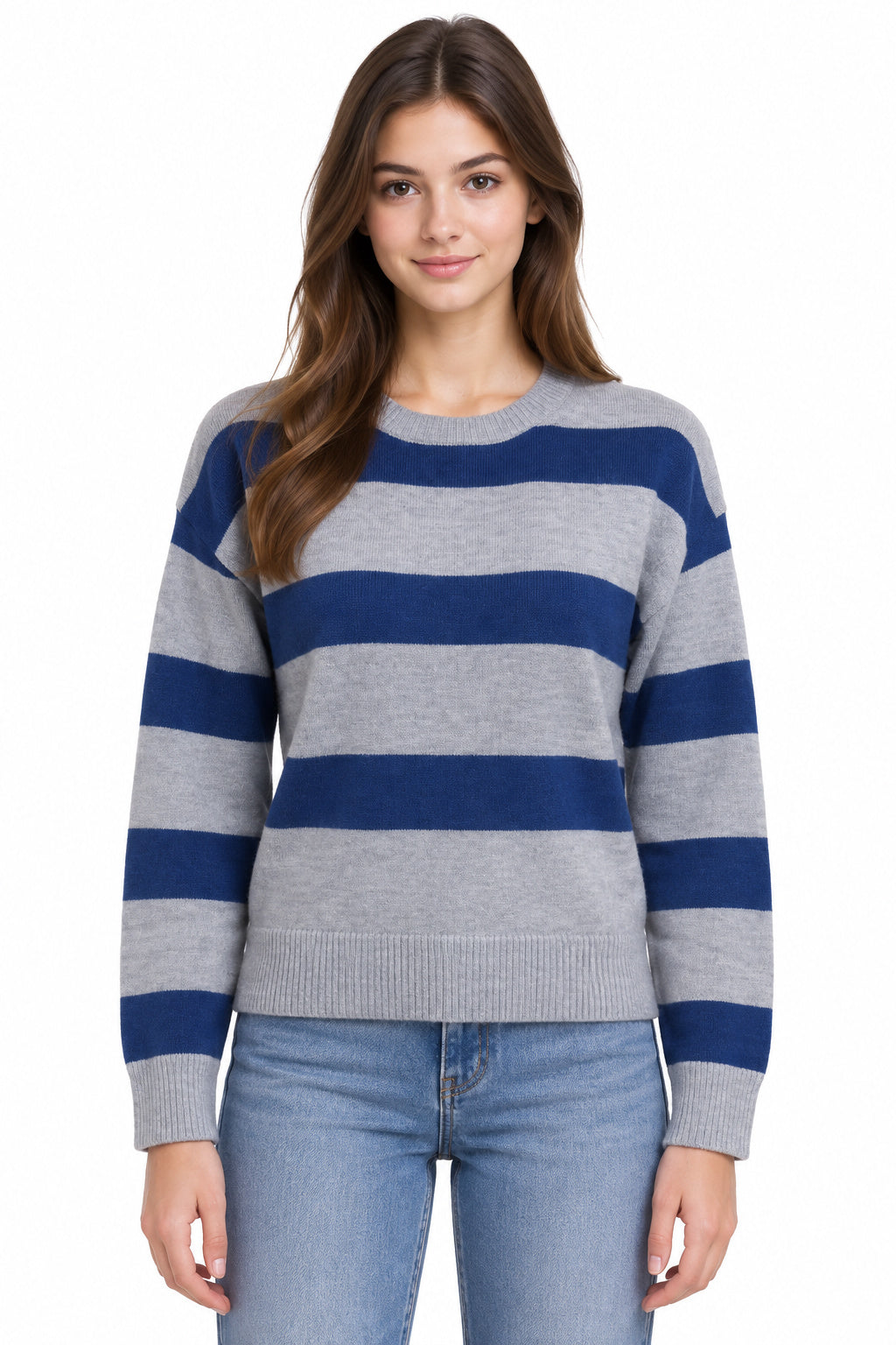 A woman wearing a gray and navy blue horizontally striped knit sweater with light wash blue jeans, photographed against a plain white background.
