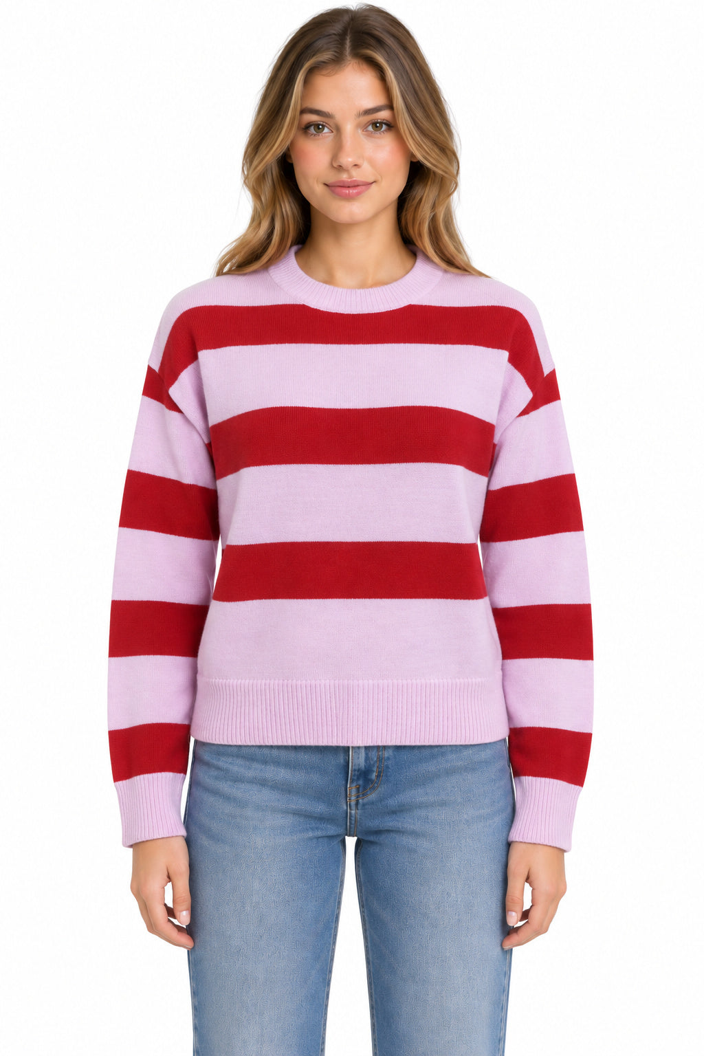 A woman wearing a light pink and red horizontally striped crewneck sweater with light blue jeans, photographed against a plain white background.